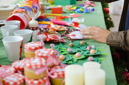 Closeup on handmade ornaments for sale at the local craft market. Colorful background