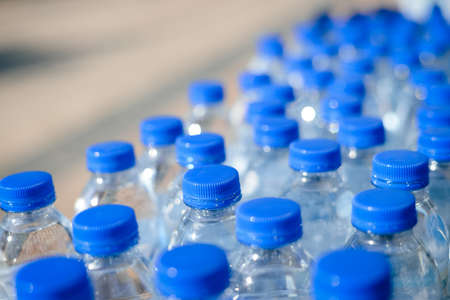 Closeup on mineral water bottles in raw and linesの写真素材