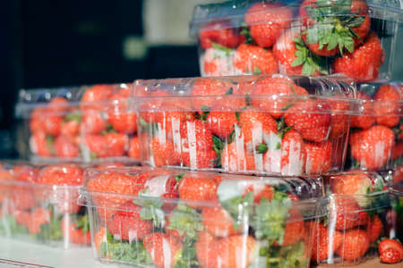 Closeup on boxes of fresh strawberries on farmer market backgroundの写真素材