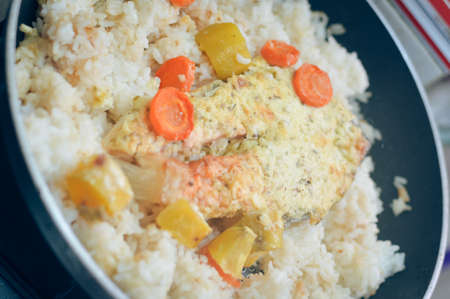 Frying pan with seafood salmon with rice and herbs. Top View. Closeupの写真素材
