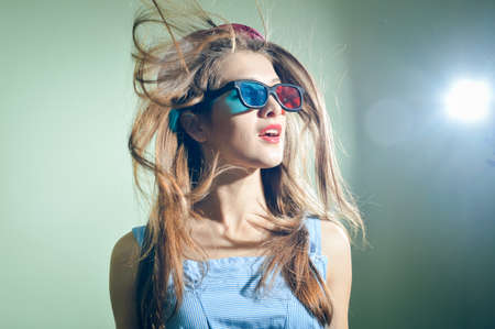 Surprised young pretty woman in 3d glasses looking up amazed. Beautiful amazing elegant romantic...