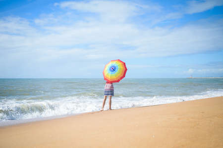 Excited romantic female having fun on beach walk on sunny background outdoorsの写真素材