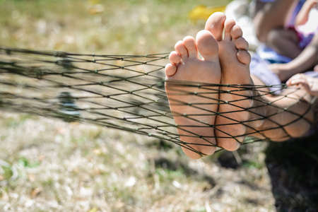 Closeup of happy family lying on hammock on sunny countryside background. Picture of man and...