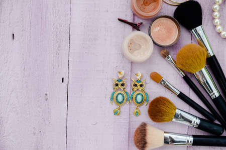 Flat lay of brushes and cosmetic on a table background. Top view closeupの写真素材