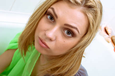 Sensual beautiful young woman in see-through dress relaxing taking bath, closeup portraitの写真素材
