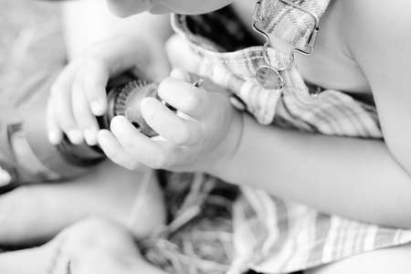 Black white photography top view child hands holding drill. Closeup picture of do it yourself concept.の写真素材