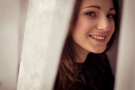 Portrait of sensual woman on light window backgroundの写真素材