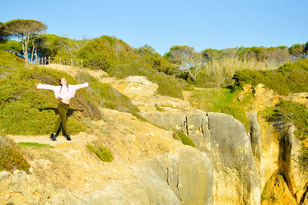 Woman on the sunny blue sky background. Back side view. Holiday, adventure, nostalgic experienceの写真素材