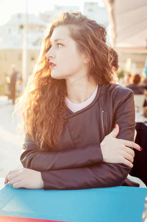 Woman sitting in restaurant cafe table sunny outdoors backgroundの写真素材