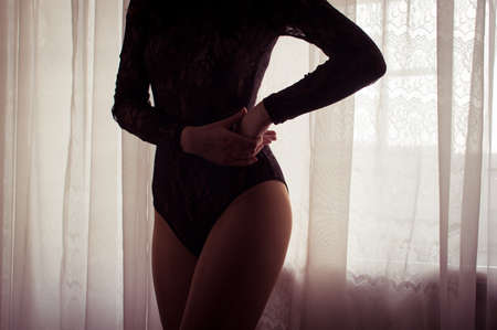 Sexy attractive young woman over light window backgroundの写真素材