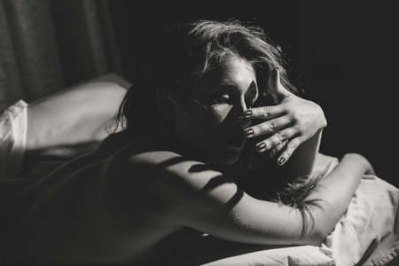 Attractive woman relaxing on the bedroom backgroundの写真素材