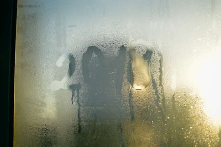 New 2018 Year blurry sign written inscription on frozen sunshine window background surfaceの写真素材