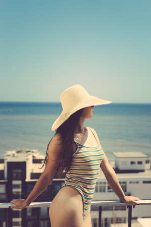 Back view of sexy woman overlooking ocean sea on sunny outdoors background. Luxury travel vacation journey lifestyleの写真素材