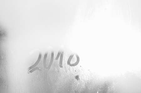 2018 painted on a misted glass window background. Close up photo of New Year drawの写真素材