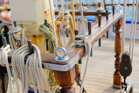 Closeup on wooden deck tackle marine rigging and ropes backgroundの写真素材