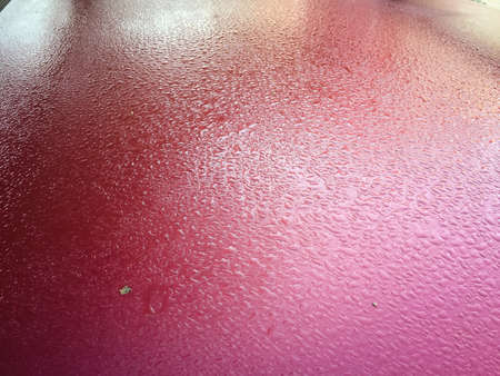 Red blurry abstract closeup water drops background. Natural condensing surfaceの写真素材