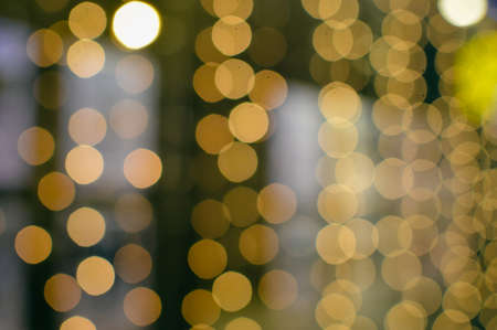 Blurry defocused festive glitter bokeh, shiny lights illumination texture backgroundの写真素材