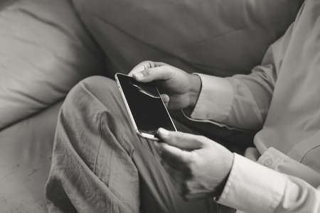 Top view close up of a man using mobile smart phone, mock up displayの写真素材