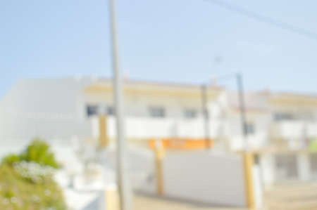 Abstract blurred view of green trees and building bright outdoors background