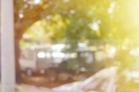 Abstract blurred view of green trees and building bright outdoors backgroundの写真素材