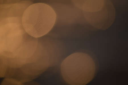Bokeh of bright golden solar flare reflections for background
