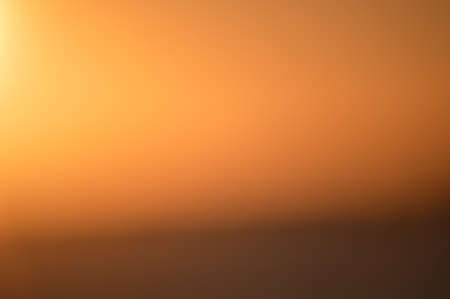 Bokeh of bright golden solar flare reflections for backgroundの写真素材