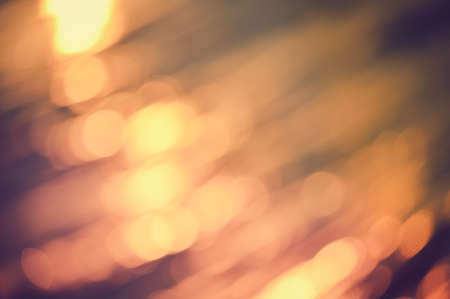 Golden bokeh light flare defocused abstract backgroundの写真素材