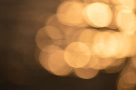 Golden bokeh light flare defocused abstract backgroundの写真素材