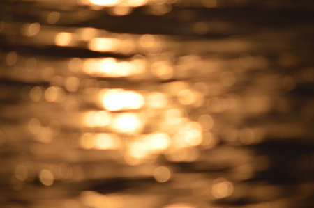 Golden bokeh light flare defocused abstract backgroundの写真素材