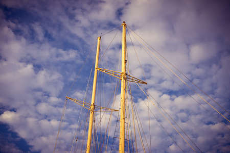 Travel vacation background. Sailing yacht mast, ropes, ocean sunny outdoorsの写真素材