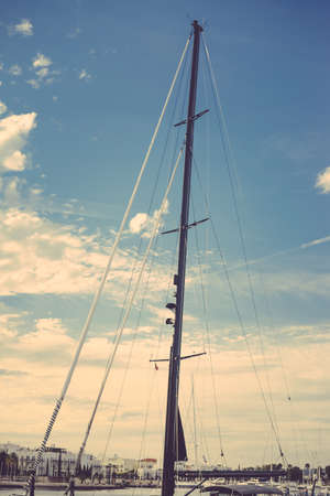 Travel vacation background. Sailing yacht mast, ropes, ocean sunny outdoorsの写真素材