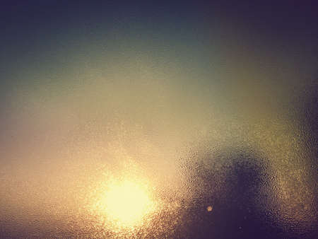 Blurred water drops on natural wet window abstract sunlight background. Close up photography of changing weather climate environmentの写真素材