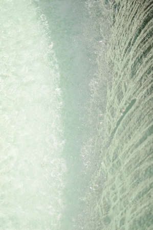 Fountain detail flowing water abstract backgroundの写真素材