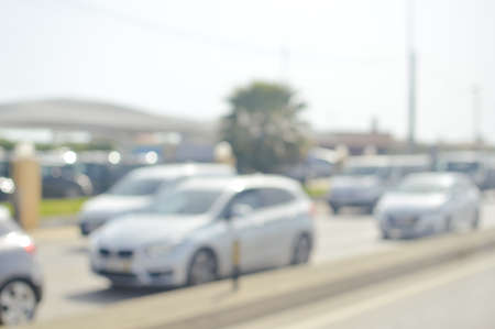 Blurred image of traffic on sunny road outdoors background. Defocused backdrop conceptの写真素材
