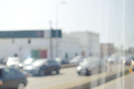 Blurred image of traffic on sunny road outdoors background. Defocused backdrop conceptの写真素材