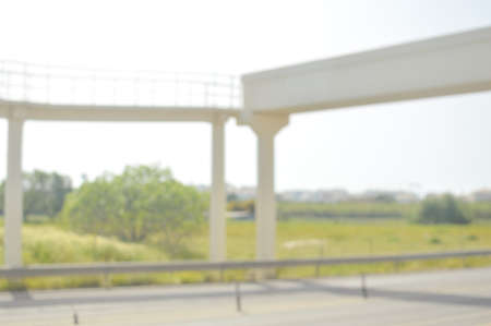 Blurred image of traffic on sunny road outdoors background. Defocused backdrop conceptの写真素材