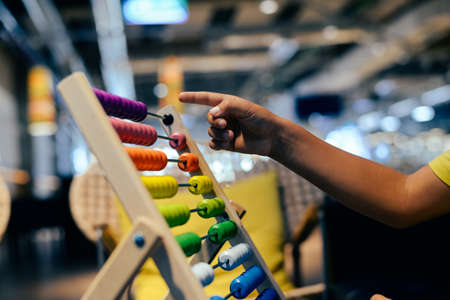 Educational colorful wooden abacus beads on table background. School arithmetic symbol, calculating thinking concept, closeup photographyの写真素材