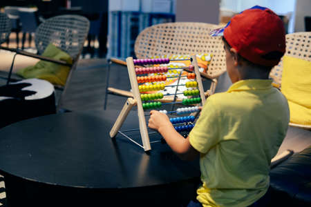 Educational colorful wooden abacus beads on table background. School arithmetic symbol, calculating thinking concept, closeup photographyの写真素材