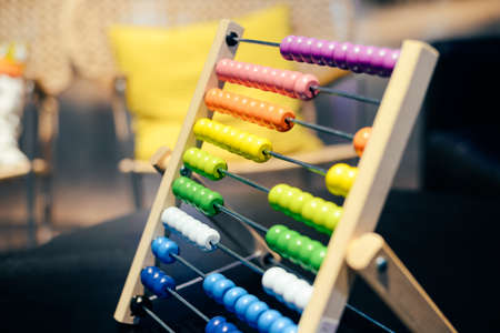 Educational colorful wooden abacus beads on table background. School arithmetic symbol, calculating thinking concept, closeup photographyの写真素材