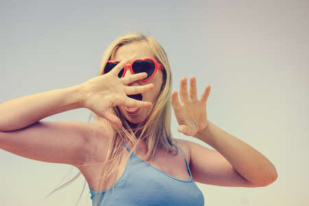 Joyful excited lovely attractive woman is watching 3 D movie. Excitement beauty young lady over light background. Funky enjoyment, surprised amazing experience. People having fun leisure lifestyleの写真素材