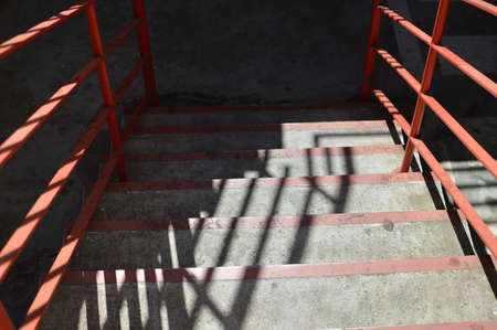 Abstract emergency stairs access for people, gray textured color empty stairway indoors grungy structureの写真素材