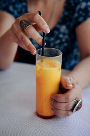 Close up on glass of fresh fruits drink over light table background. Healthy positive lifestyleの写真素材