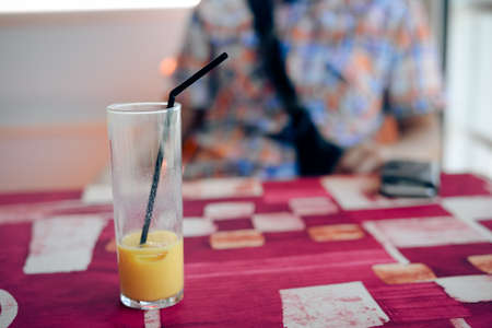 Close up on glass of fresh fruits drink over light table background. Healthy positive lifestyleの写真素材