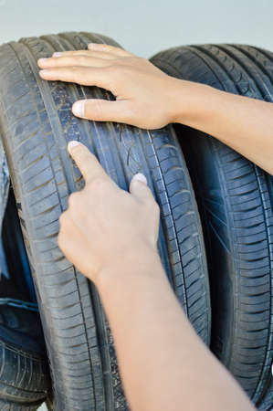 A person hand checking holding car wheels abstract transportation industrial background. Dealership auto service, repairing point, producer stationの写真素材