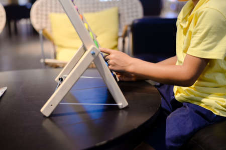 Close up on colorful abacus playful activity, educational interior background. Happy joyful developmental lifestyleの写真素材