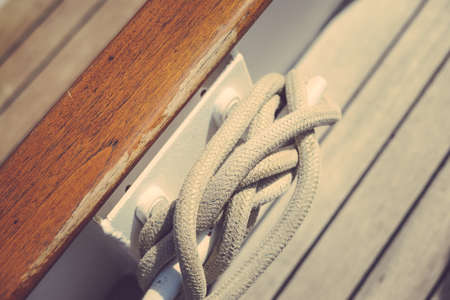 Closeup on wooden deck tackle marine rigging and ropes backgroundの写真素材