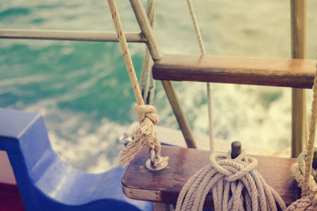 Closeup maritime equipment detail of deck, ropes on sailing boat, abstract transportation backgroundの写真素材