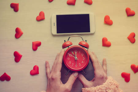 Aboveview on lovely mobile digital smart device over wooden desktop background. Close up photography. Modern multimedia information equipment gadget, creative template organized flat lay styleの写真素材