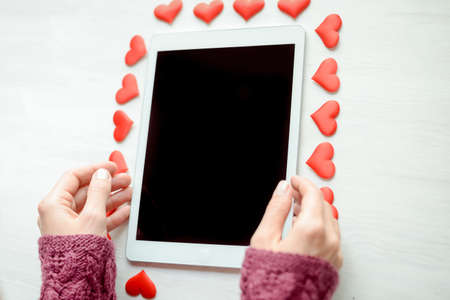 Aboveview on lovely mobile digital smart device over wooden desktop background. Close up photography. Modern multimedia information equipment gadget, creative template organized flat lay styleの写真素材