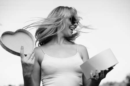 Joyful young woman happy smile hold gift box in hands, bright close up portrait. Emotional delight lovely happiness lifestyle. Amazing excitememntの写真素材